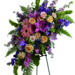 Cuscino funebre dai fiori di colore tenue a Roma